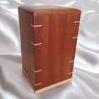 Handcrafted memorial urn made from solid hardwood with secure closure and simple design