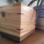 Handcrafted wooden urn for animal ashes with paw prints, made in Canada
