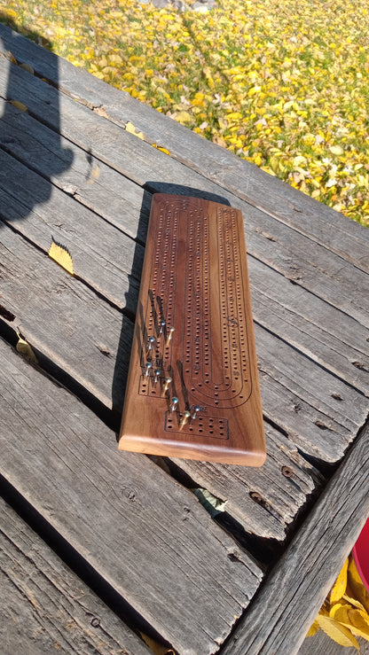 Handcrafted Wood Cribbage Boards with peg storage. A practical gift for all occasions.