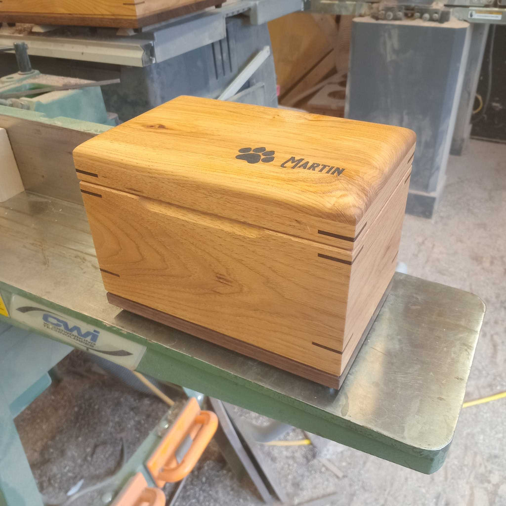 Custom handcrafted wood box urn with paw print design for pet ashes keepsake