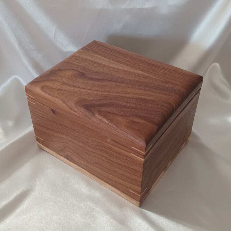 Custom wooden urn handcrafted in Canada shaped like a treasure chest for full ashes storage