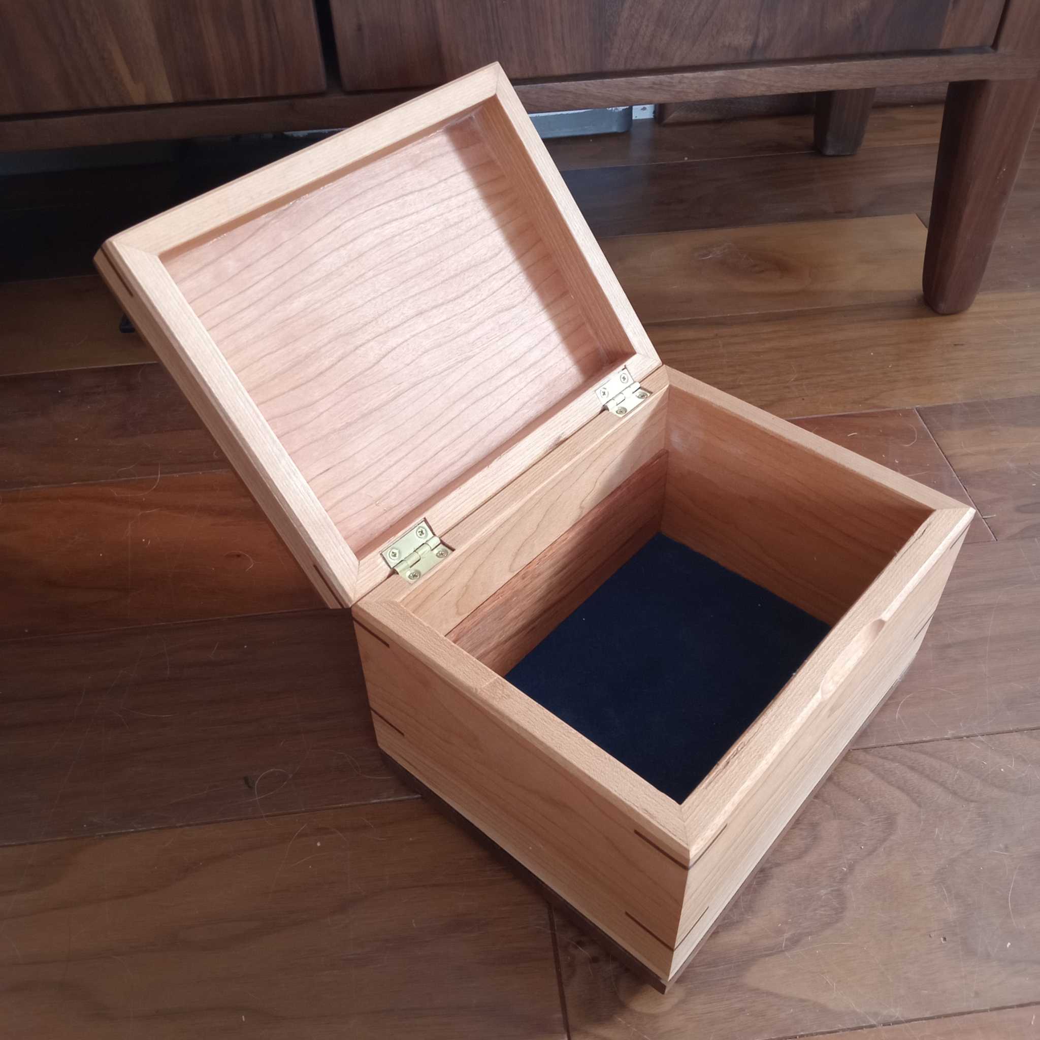 Handcrafted cremation urn made of domestic hardwood with open paw design for pet memorial