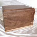 Handcrafted wooden urn for animal ashes with paw print design, made in Canada