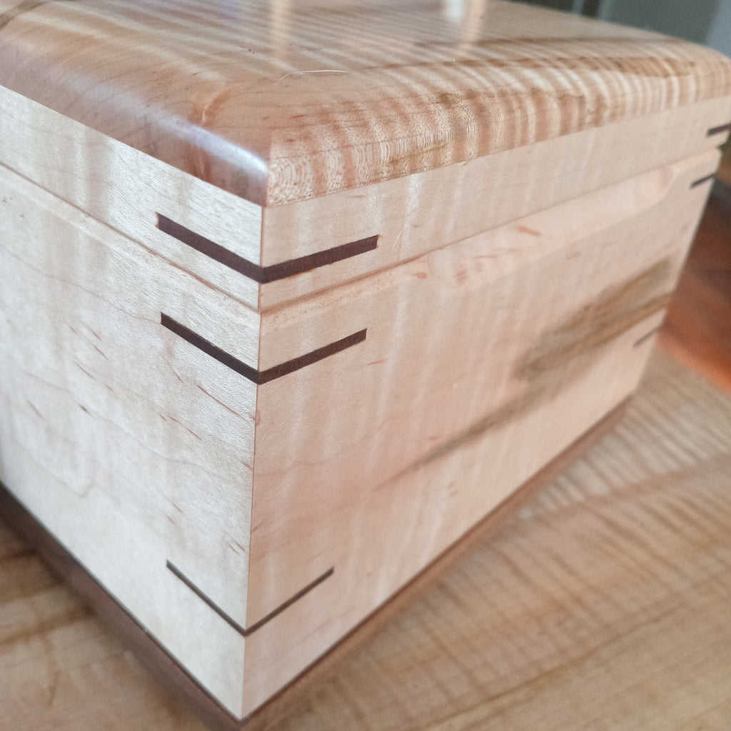 Handcrafted hardwood memory keepsake box with mitered corners and brass hinges for preserving precious items