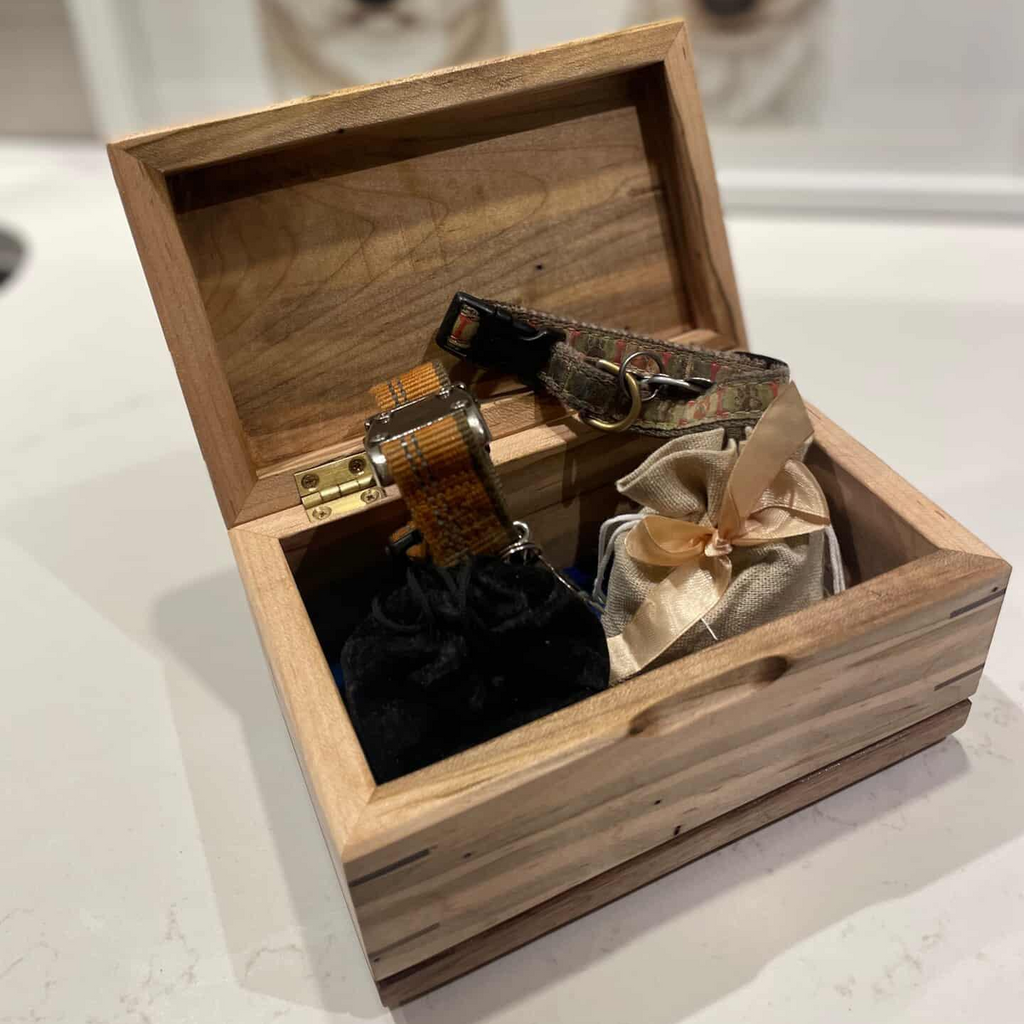 Handcrafted wooden cremation urn for pets with open paw design and custom engraving options