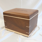 Two handcrafted black walnut wooden urns, Twilight Grove and True North, for ashes, displayed side by side