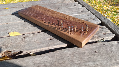 Handcrafted Wood Cribbage Boards with peg storage. A practical gift for all occasions.