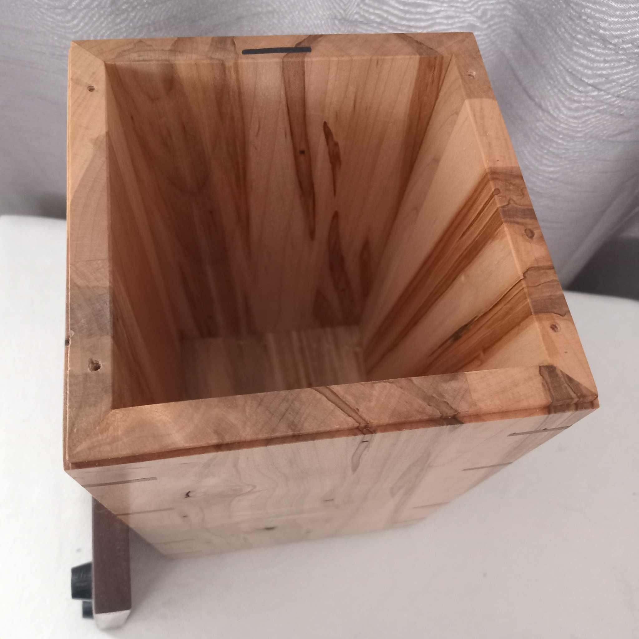 Handcrafted memorial urn made from solid hardwood with a simple, natural design