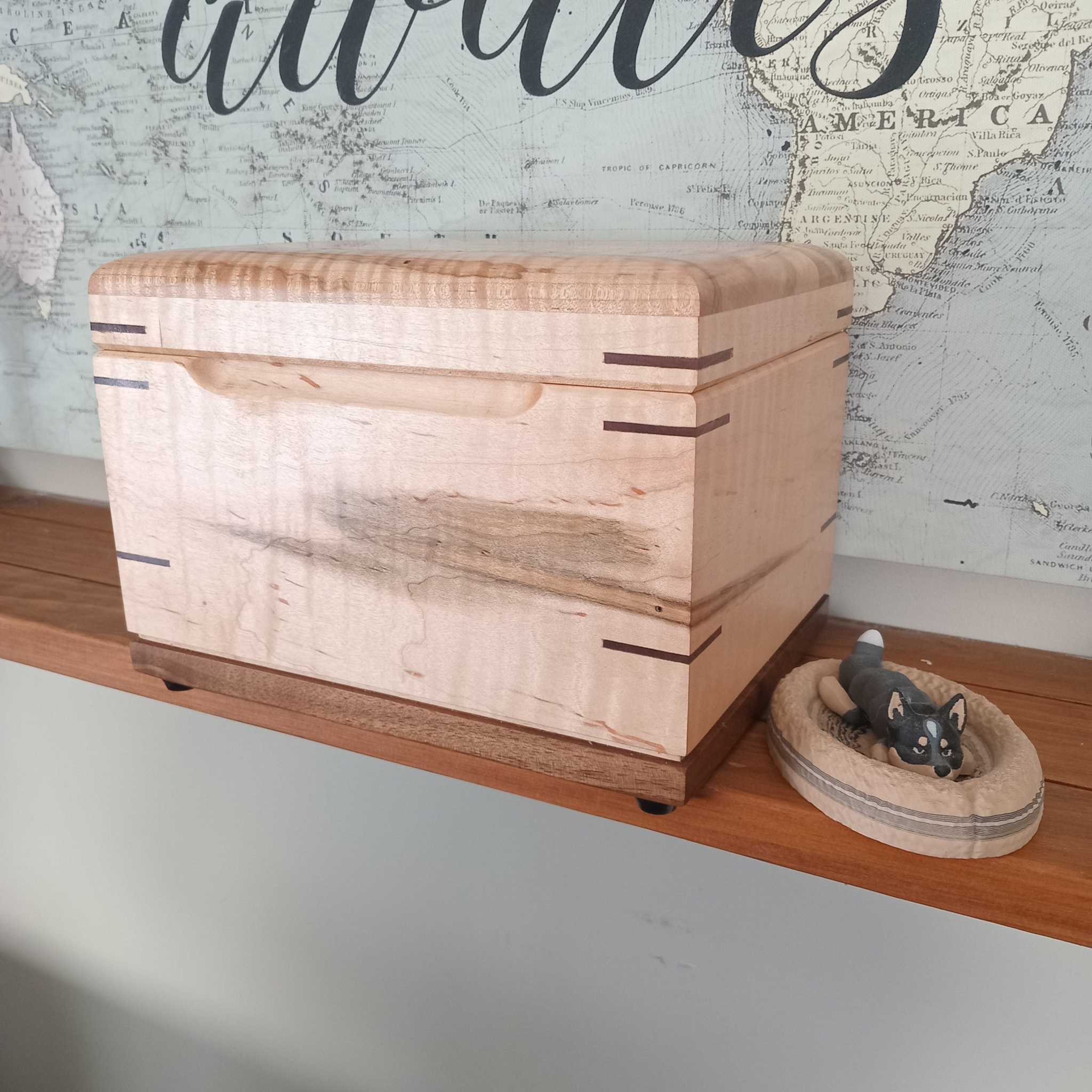 Handcrafted wooden cremation urn for pets with open paw design and custom engraving options