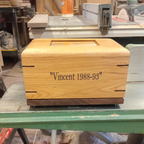 Custom personalized hardwood pet urn with paw prints and photo slot for ashes memorial