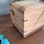 Handcrafted wooden urn for animal ashes with paw prints, made in Canada from solid hardwood