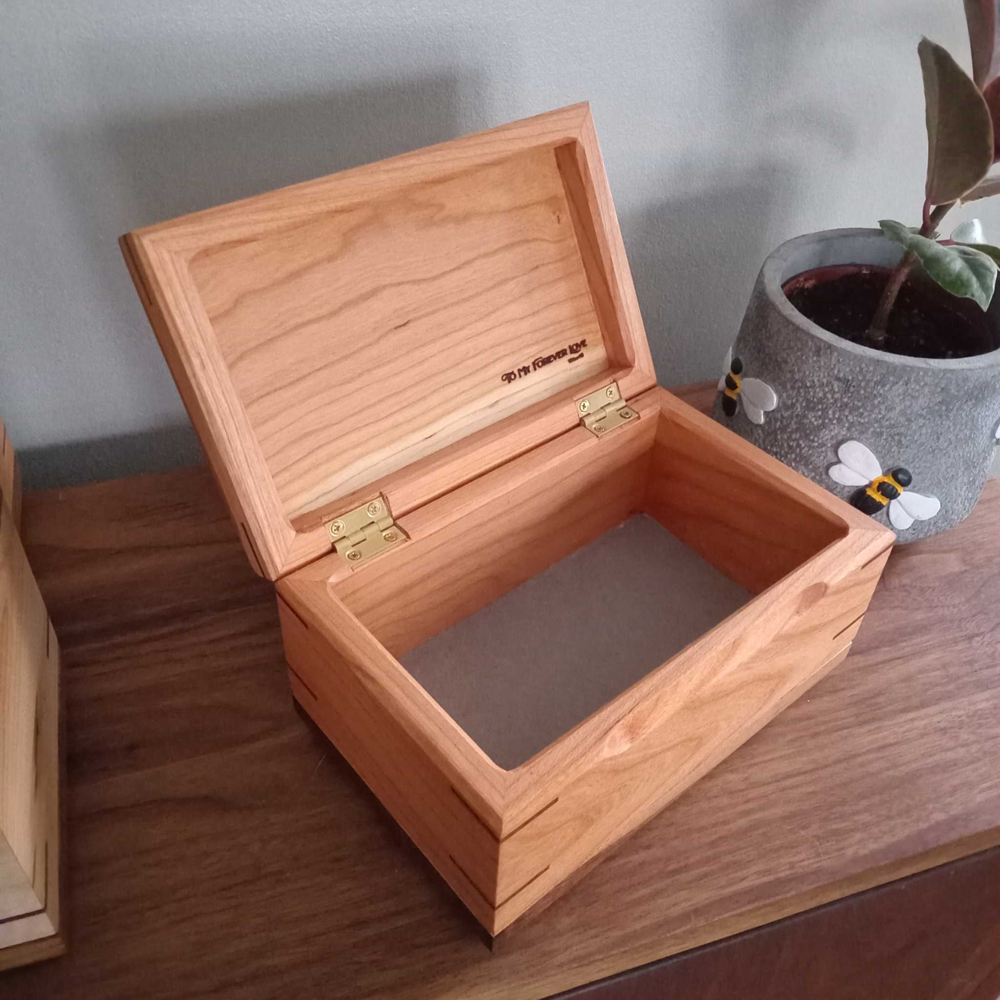 Handcrafted cremation urn for pets made from solid hardwood with custom engraving option