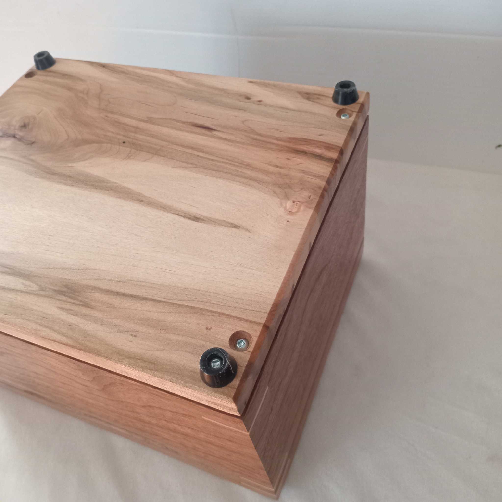 Handmade custom wooden urn shaped like a treasure chest, crafted in Canada with secure closure and customizable engraving options