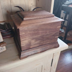 Traditional handmade memorial urn crafted from solid hardwood with a smooth finish