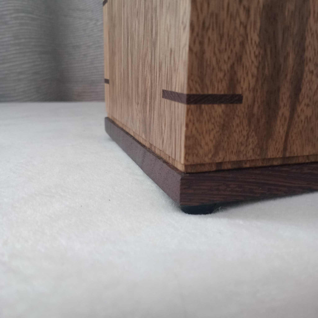 Handcrafted memorial urn made from solid hardwood with a natural finish and secure lid