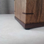 Handcrafted memorial urn made from solid hardwood with a natural finish and secure lid