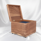 Handmade custom wooden urn shaped like a treasure chest, crafted in Canada