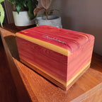 Handcrafted wooden urn for animal ashes with paw print design, made in Canada.